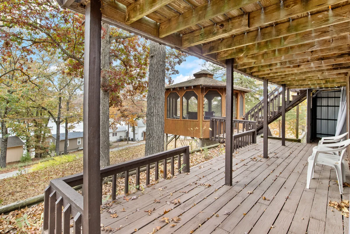 Featuring a deck area surrounded by trees and a charming treehouse, this scene highlights a serene outdoor space for relaxation and entertaining. The dense foliage underscores privacy, and the elevated vantage points suggest a secure, protected atmosphere.